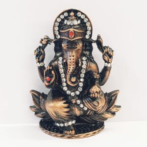 Image of a copper shaded Car dashboard Idol of Lord Ganesha