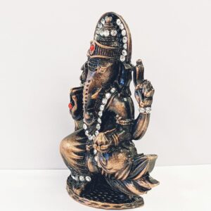 Image of a copper shaded Car dashboard Idol of Lord Ganesha with stone work