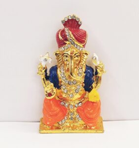 Image of a Car dashboard idol of Ganesha wearing a Pagdi