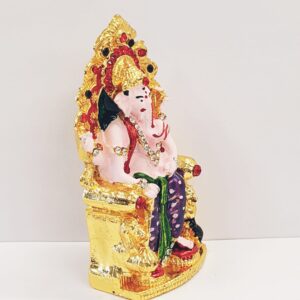side view Image of a Car dashboard Idol of Ganesha sitting on a throne
