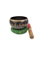 Image of a 5 inches Tibetan Singing bowl with a wooden mallet placed on a Cushion Cover