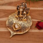 Ganesha on Beetle leaf with a diya in front