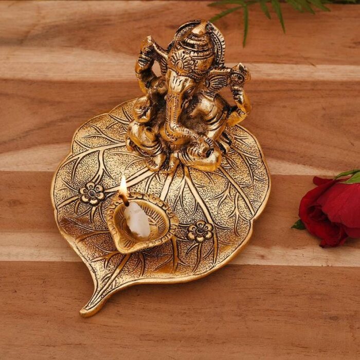 Ganesha on Beetle leaf with a diya in front