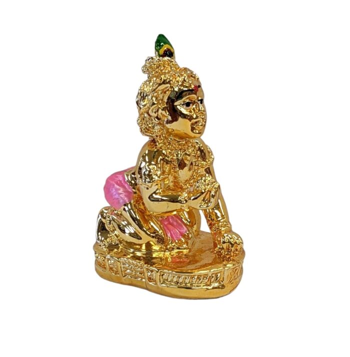 image of a gold plated laddu gopal krishna car dashboard idol