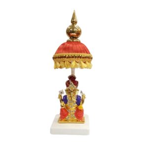 Image of a Car dashboard Idol of Ganesha with a red colored Chattar on top