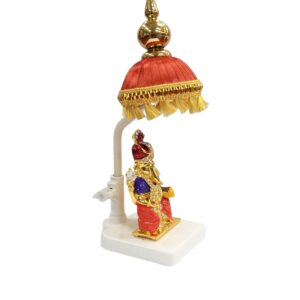 Image of a Car dashboard Idol of Ganesha with a red colored Chattar on top - side view