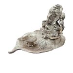Ganesha on Beetle leaf with a diya in front