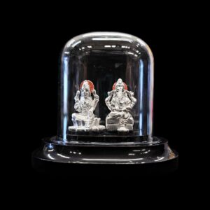 999 Pure Silver Lakshmi Ganesha Idol in acrylic dome, ideal for puja, gifting, or décor. Finely crafted with 99.9% pure silver & glitter finish.