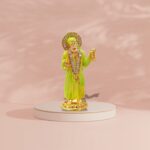 Buy Sai Baba car dashboard idol in Canada and US. Green Sai Baba idol on a pink background.