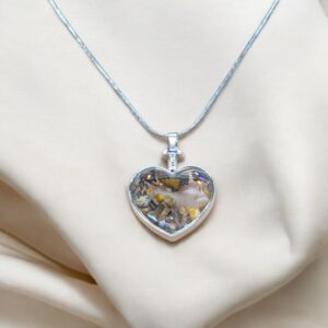 Natural Tiger eye stone encased in a Glass Heart shaped pendant