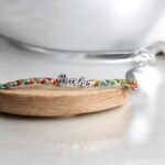 Send Love Across Borders : "Brother" Emblem Colorful Knotted Rakhi