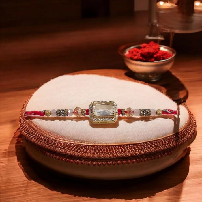 Send Rakhi to Canada: Colorful threads with Large Stone emblem
