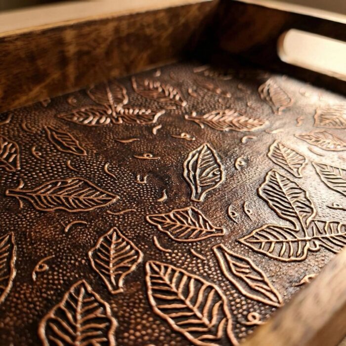 Close up on the handcrafted wooden tray with metal inlay