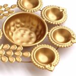 Close up of Peacock urli with golden finish