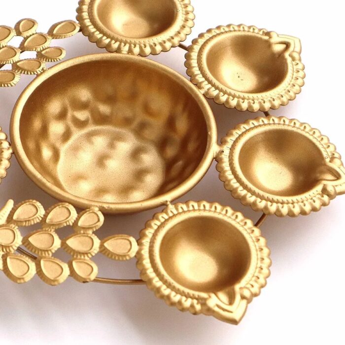 Close up of Peacock urli with golden finish