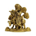 Detailed close-up of a handcrafted pure brass Lord Krishna with cow statue.