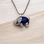 Close up of the natural celestite necklace on elephant pendant