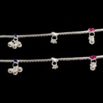 Close up of small trinklets on the silver anklets