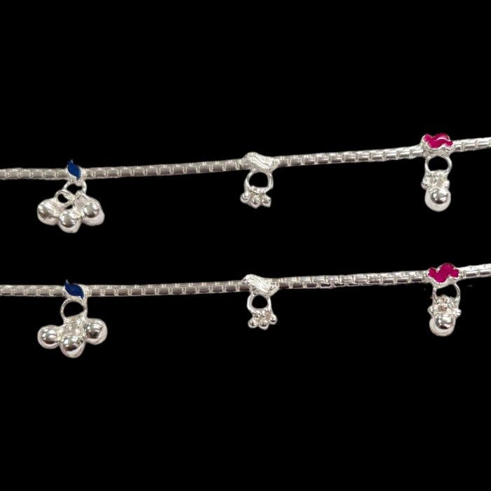 Close up of small trinklets on the silver anklets