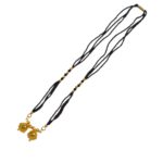 Detailed view of the high-quality gold plating and shine on the Two Wati pendant.