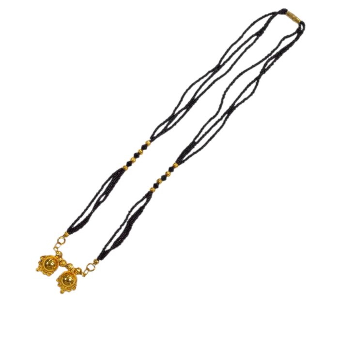 Detailed view of the high-quality gold plating and shine on the Two Wati pendant.