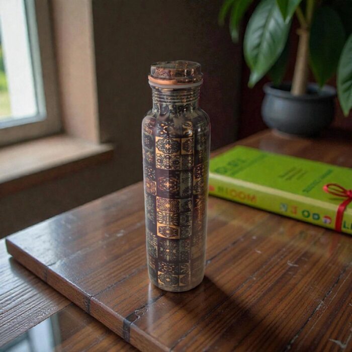 Artisan-made copper water bottle from India, shown on a wooden table.