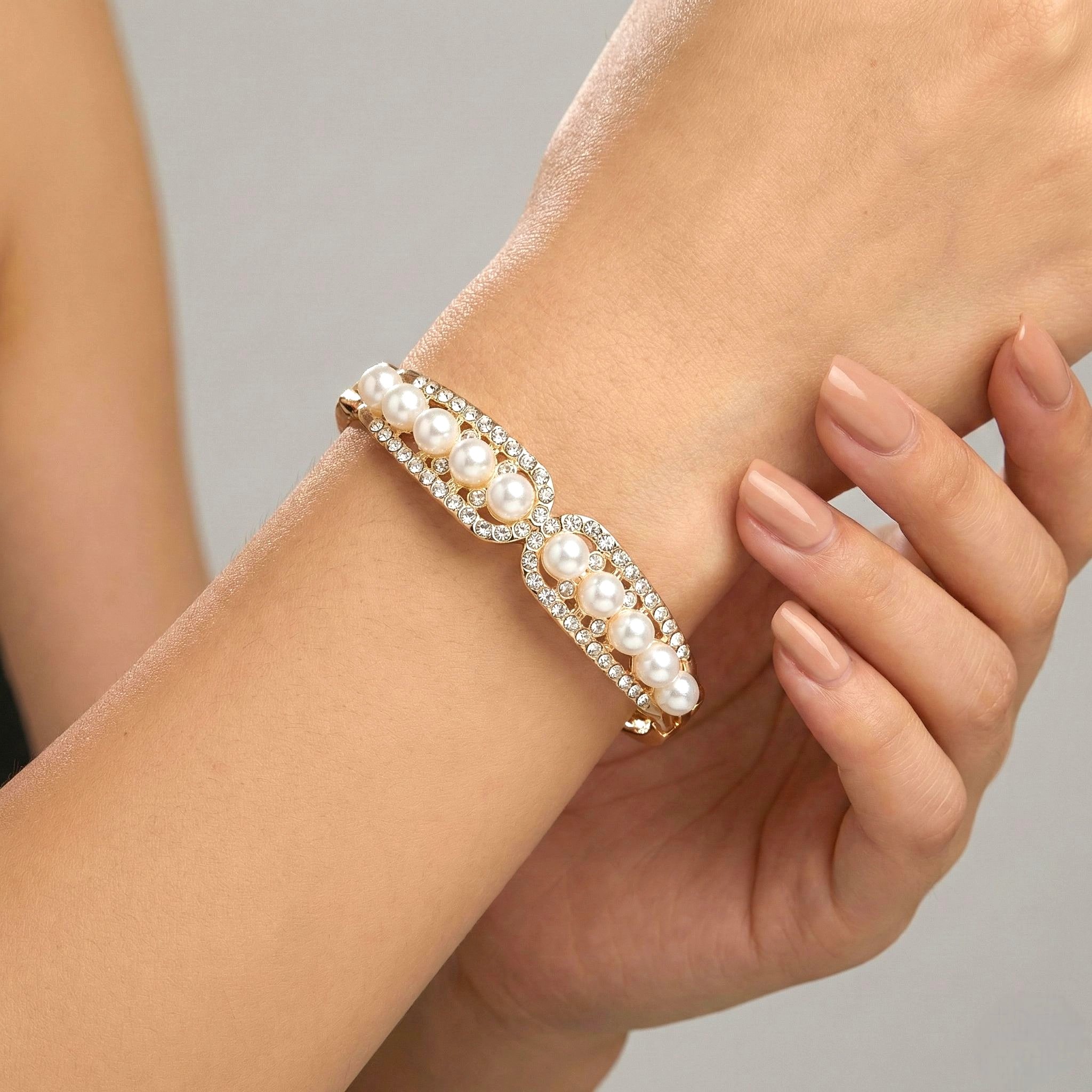1768683654117.webp Elegant Gold-Tone Pearl & AD Stone Curved Bangle - Image 1