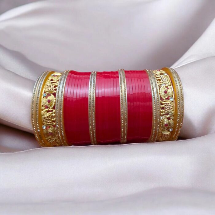 Intricate elephant design with cz stones on the golden kada of the bridal chura.