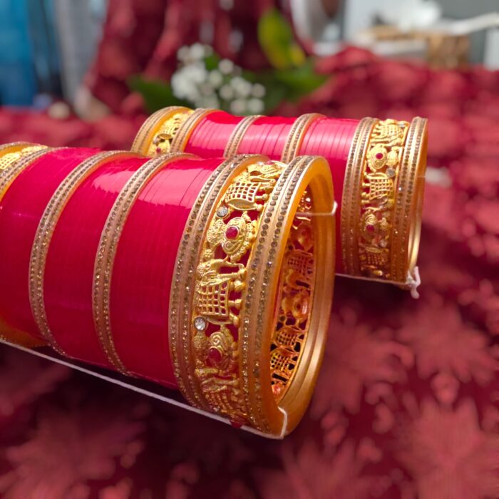 Close-up view of the golden kada on bridal chura, showing detailed elephant motifs and sparkling cz stone work. Perfect Bridal Chura.