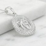 Side profile view of this Pure silver pendant with Ek onkar surrounded by studded Zirconia stones