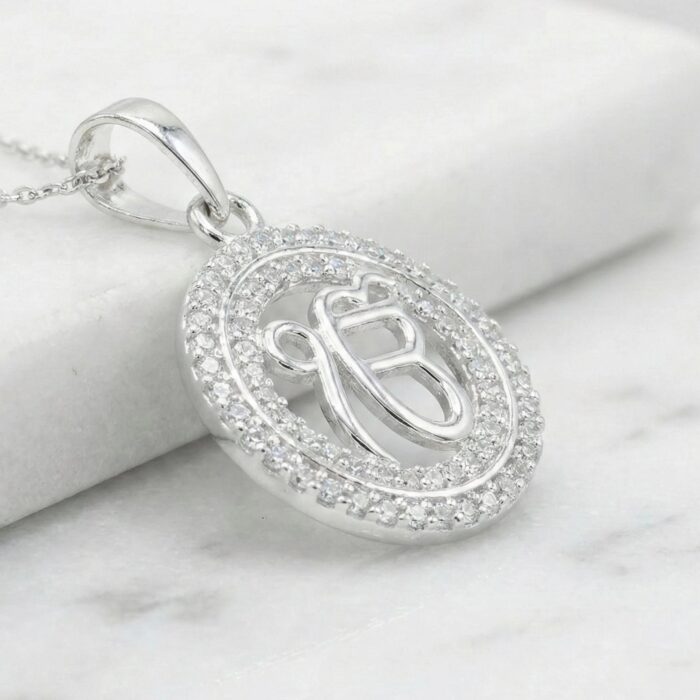 Side profile view of this Pure silver pendant with Ek onkar surrounded by studded Zirconia stones