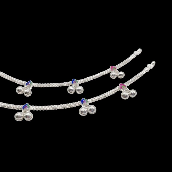 Close up of silver anklets with trinkets