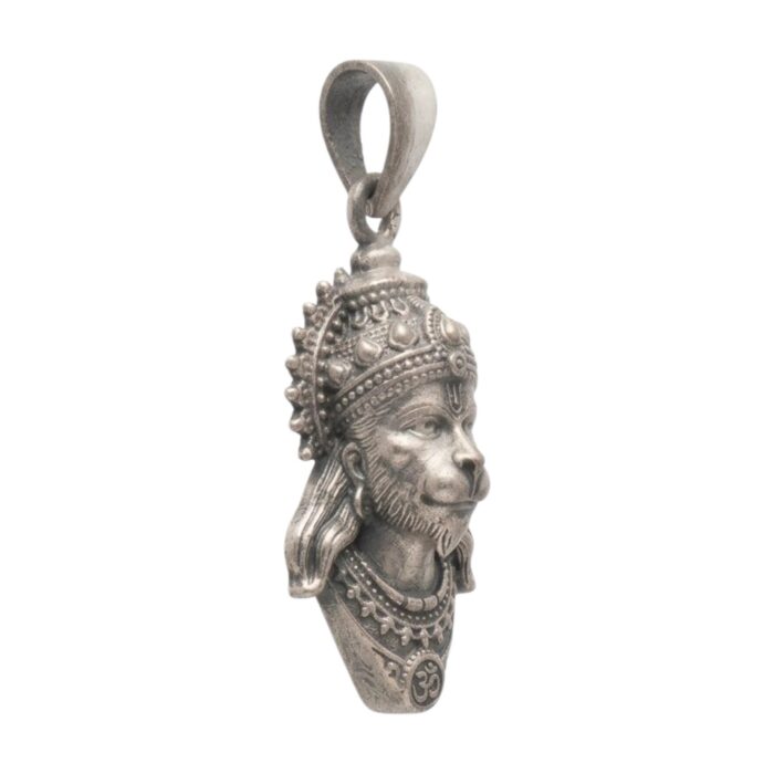 Side profile view of the silver pendant of Hanuman