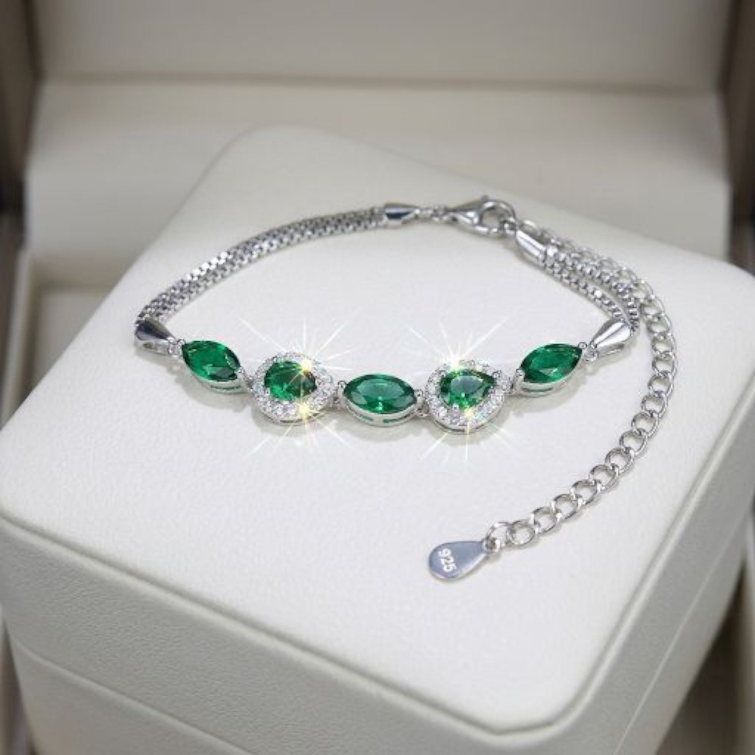Close up of the 925 sterling silver bracelet with emerald green stones