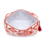 Close-up of red quilted cotton travel pouch showing Indian block print and plastic inside lining