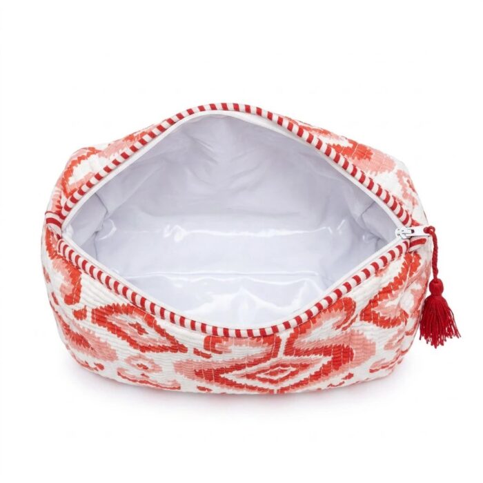 Close-up of red quilted cotton travel pouch showing Indian block print and plastic inside lining