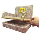 Singhasan seat lifted open to reveal built-in storage box for deity dresses, mukut and ornaments