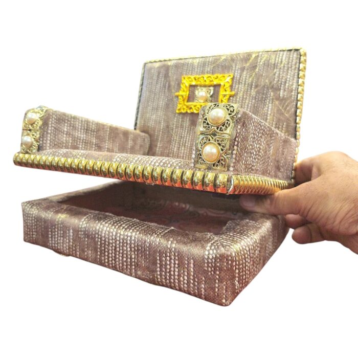 Singhasan seat lifted open to reveal built-in storage box for deity dresses, mukut and ornaments