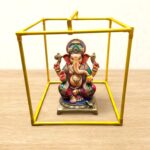 Scale photo showing a 12 inch Ganesh idol inside the 15 inch metal makhar cube