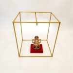 Scale photo showing a small Ganesh idol inside the 24 inch metal makhar cube
