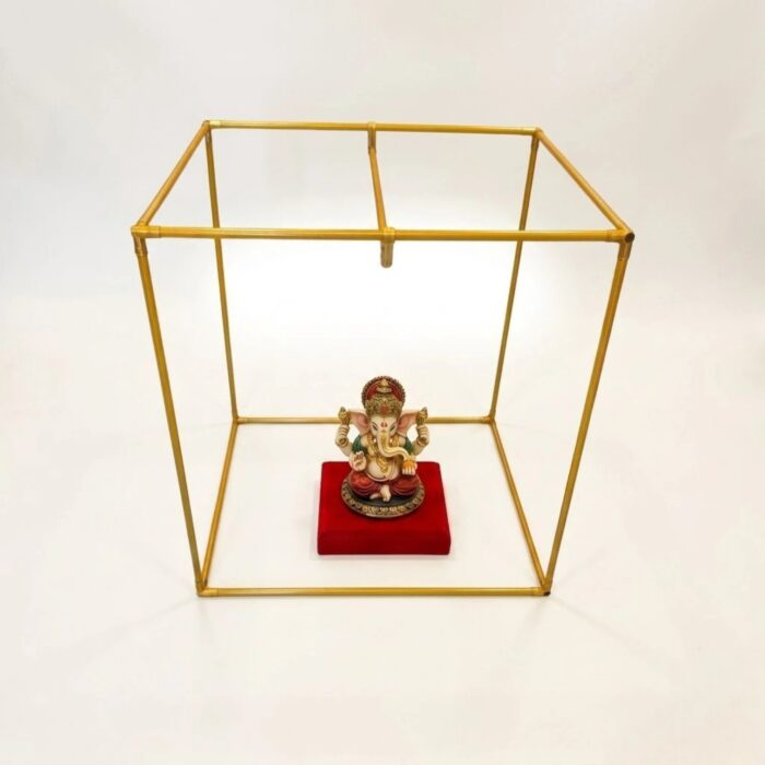 Scale photo showing a small Ganesh idol inside the 24 inch metal makhar cube