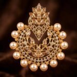 Macro detail of marquise champagne crystals and pearl fringe on Gehna chandbali earring