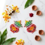 Acrylic Shubh labh being used as center pieces in a marigold rangoli for Diwali Decoration