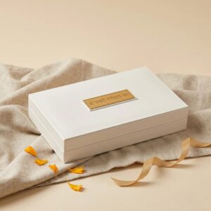 Close view of Lakshmi Ganesh gold plated gift box showing Charan Paduka