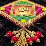 Close up of Red Acrylic base with handpasted bead work Shubh Labh
