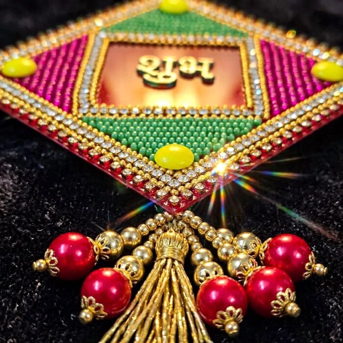 Close up of Red Acrylic base with handpasted bead work Shubh Labh