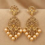 7 cm gold-tone drop earrings styled on champagne silk