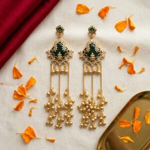 Pair of green onyx Kashmiri ghungroo earrings standing on emerald silk