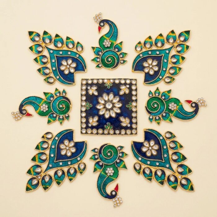 Close-up of teal and emerald peacock metal rangoli pieces with gold-tone trim.