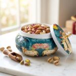 Open pichwai metal jar filled with dry fruits | Dry fruit serving jar